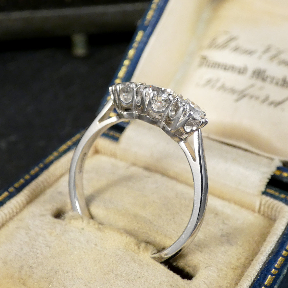 Platinum ring with diamonds on a textured surface