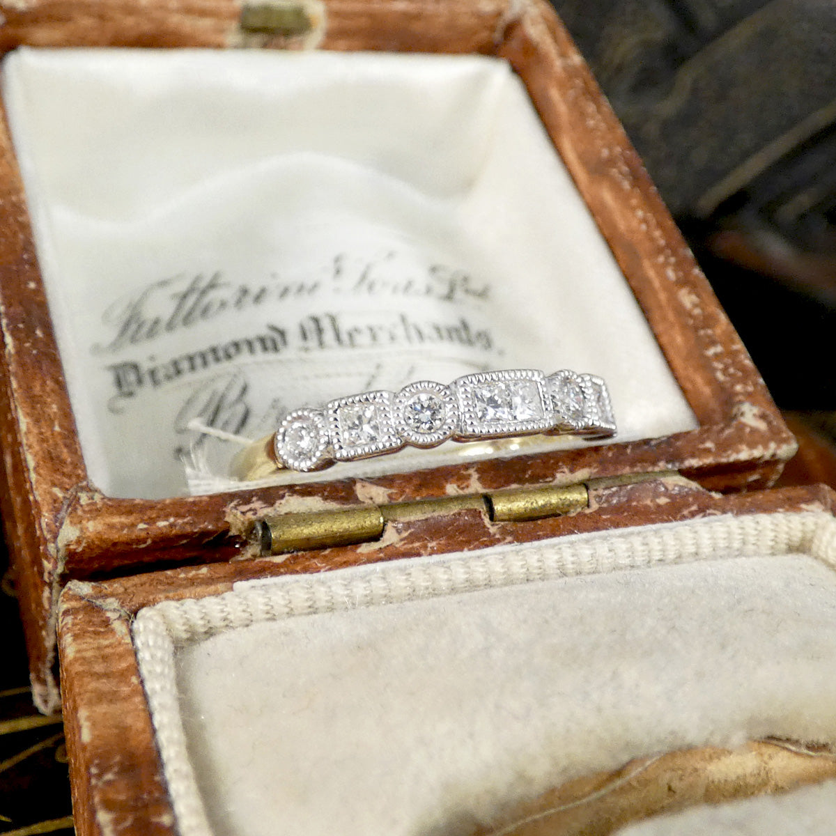 Diamond ring in an open jewelry box.