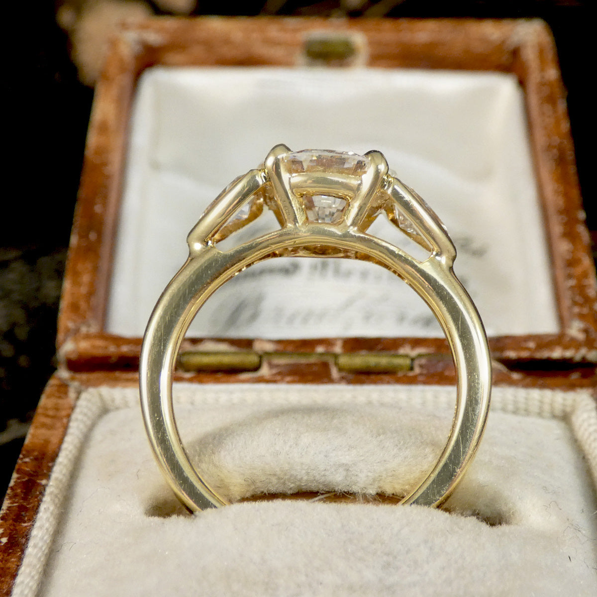 Gold ring with a diamond in an open jewelry box