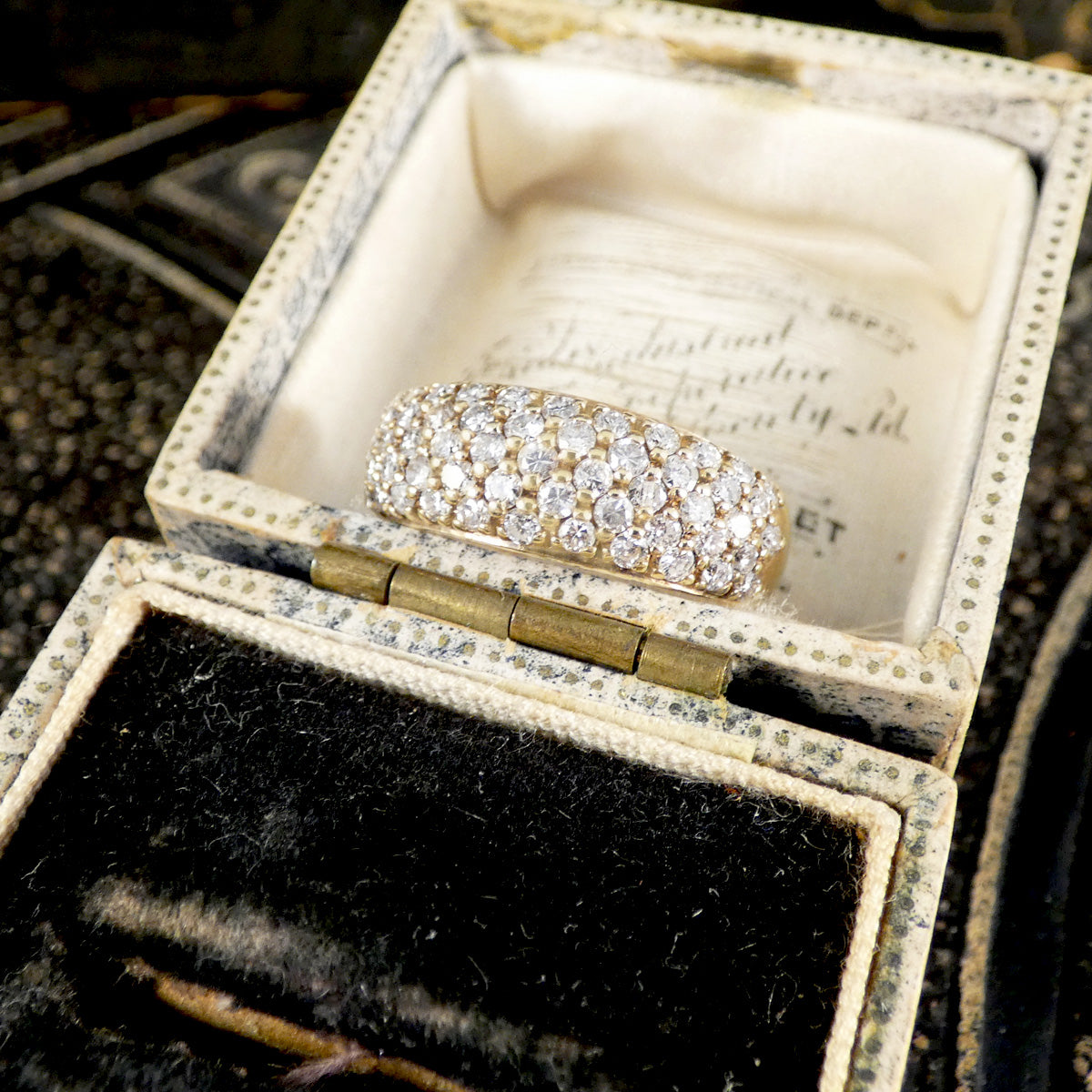 a domes diamond set ring in yellow gold in a jewellery box