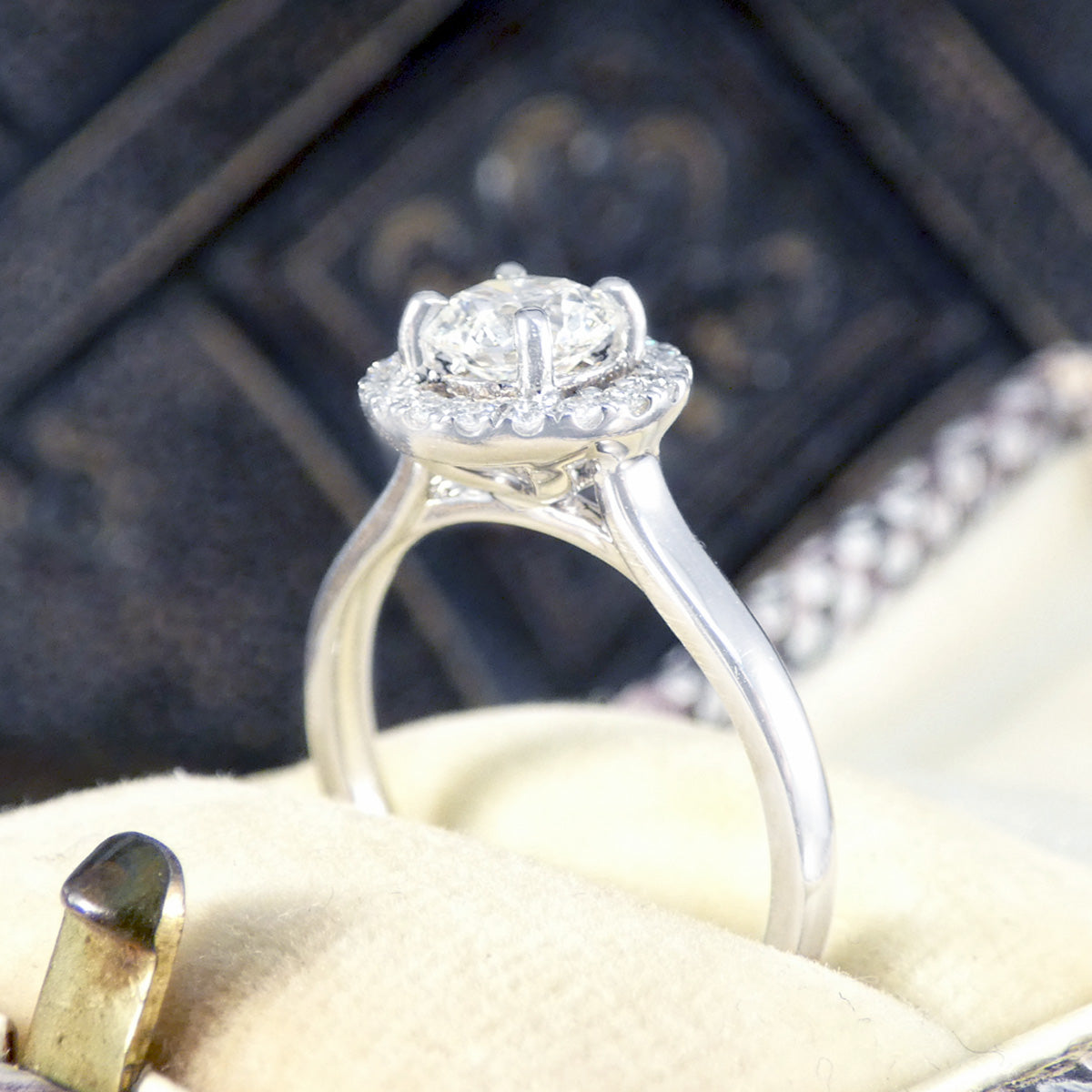 Side profile of diamond cluster engagement ring.