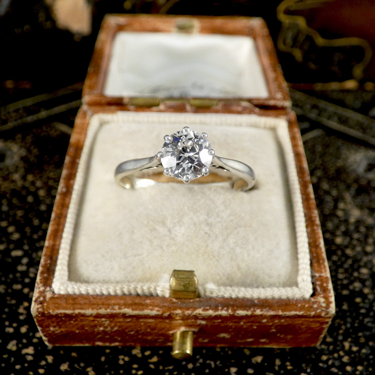 An old cut diamond solitaire ring in 18ct white gold and platinum displayed in jewellery box.