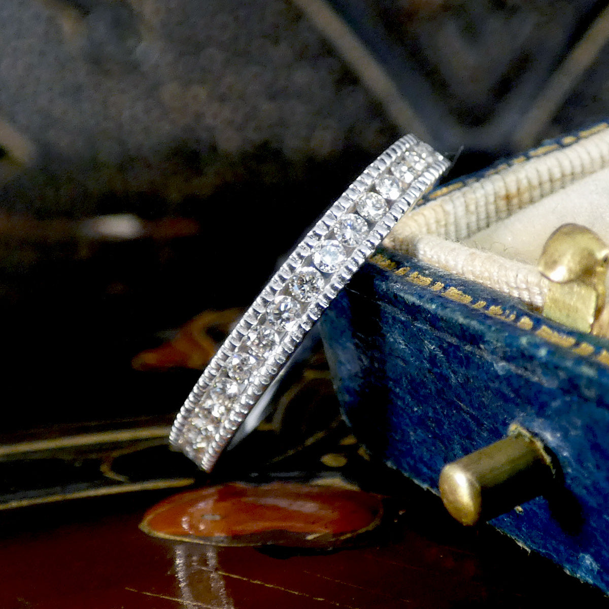 Silver ring with diamonds on a violin