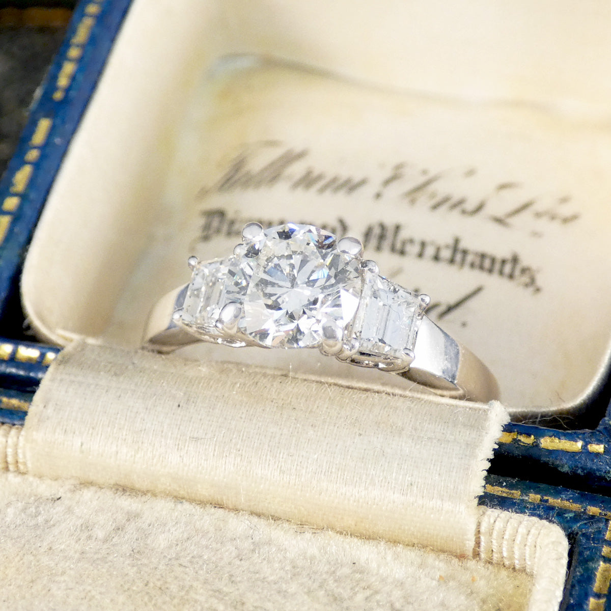 A brilliant cut and trapezoid cut Diamond three stone ring.