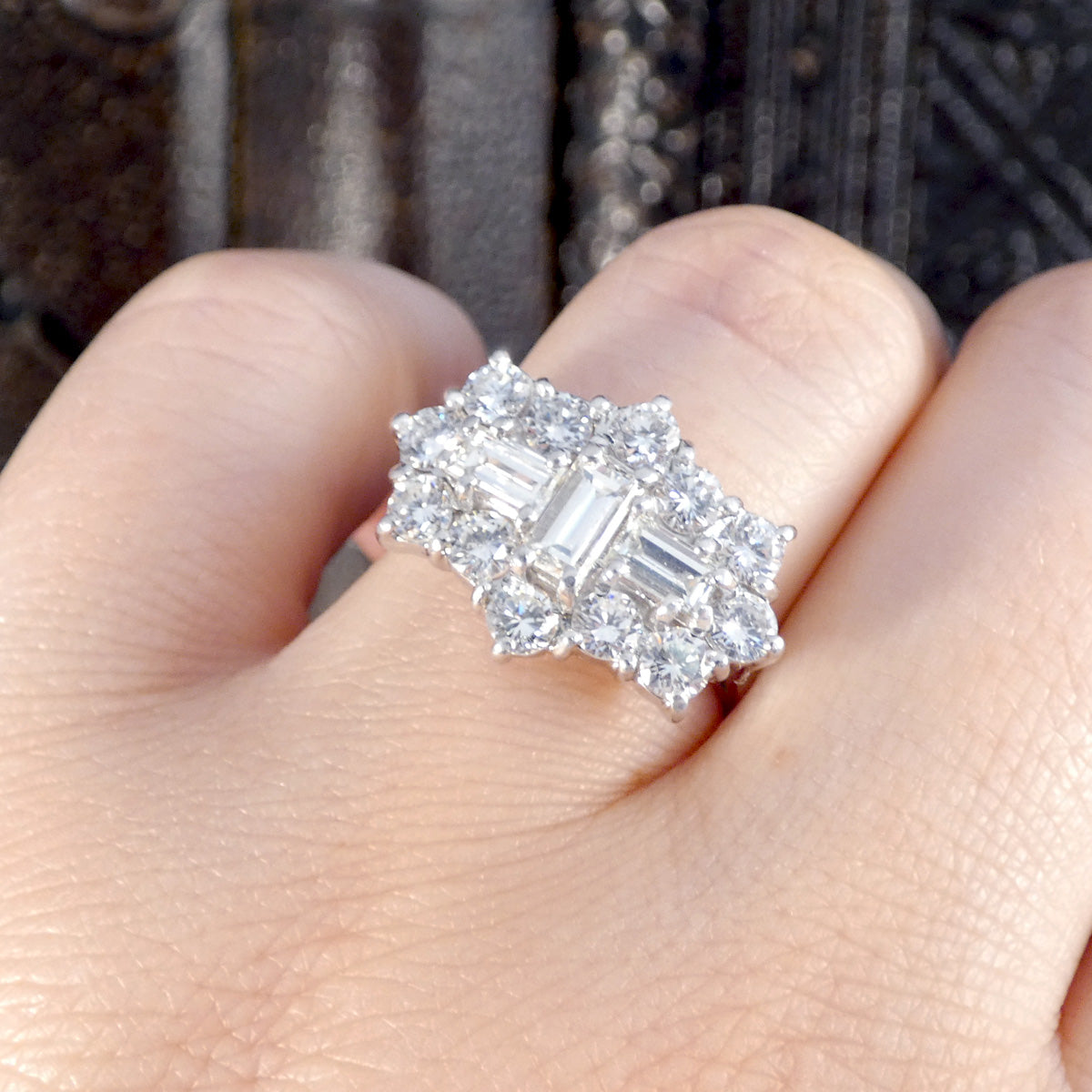 A close up of diamond boat ring on the finger showing mass sparkle.