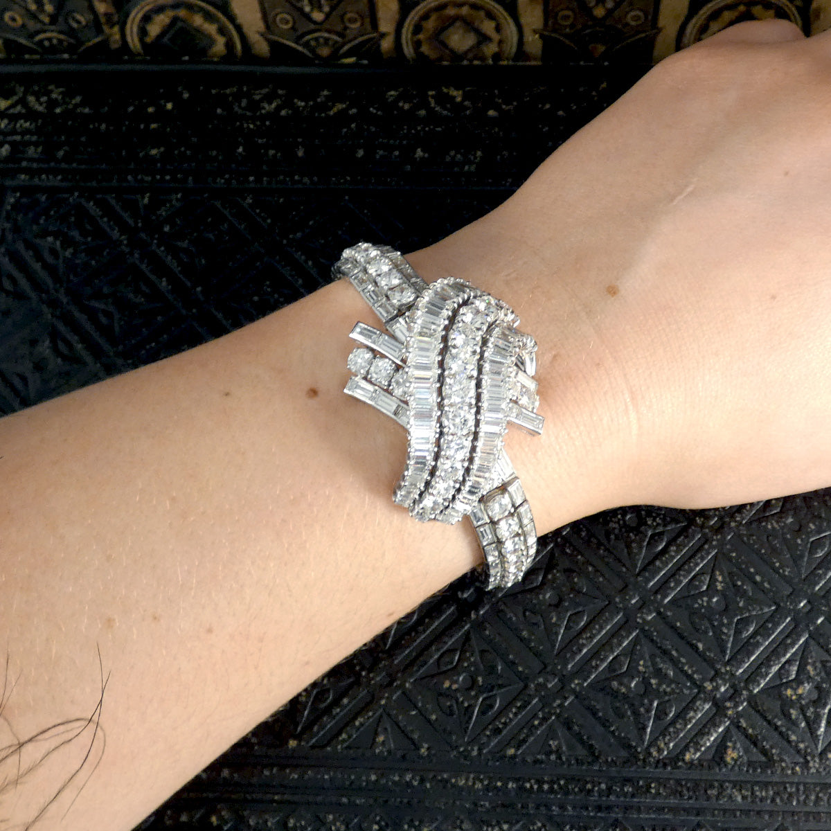 1950's French diamond bracelet featuring an intricate design with approximately 30ct of diamonds, elegantly showcased on the wrist to highlight its fit and glamour.