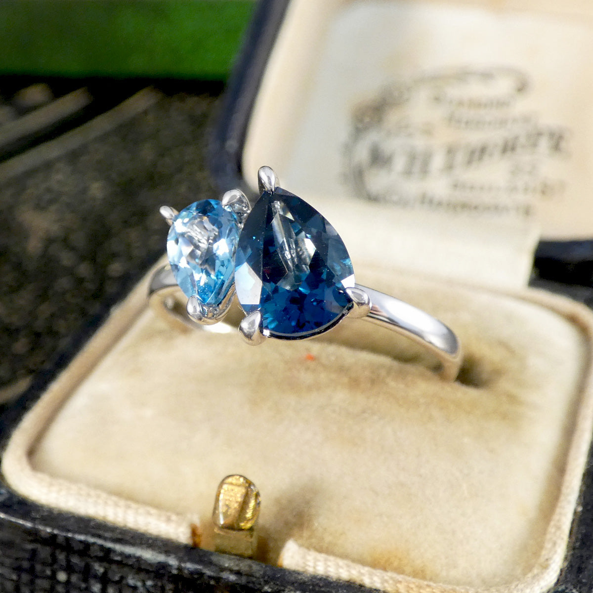 white gold toi et moi ring with blue topaz gemstones in a jewellery box