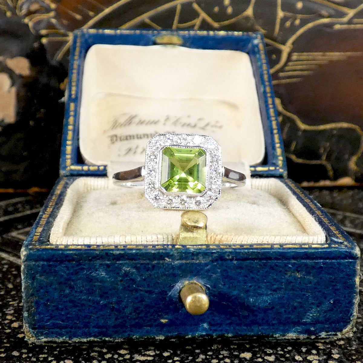 Art Deco Style Peridot and Diamond Cluster Ring in Platinum shown in vintage box.