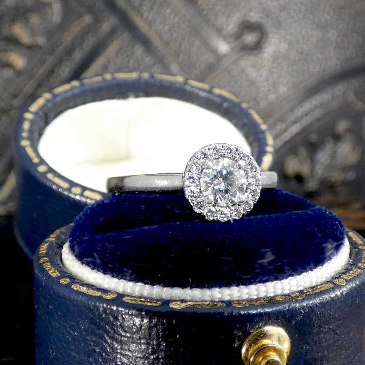 Diamond ring in a blue jewelry box with a blurred background