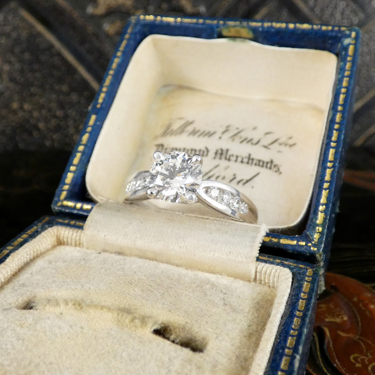 Diamond ring in an open jewelry box.