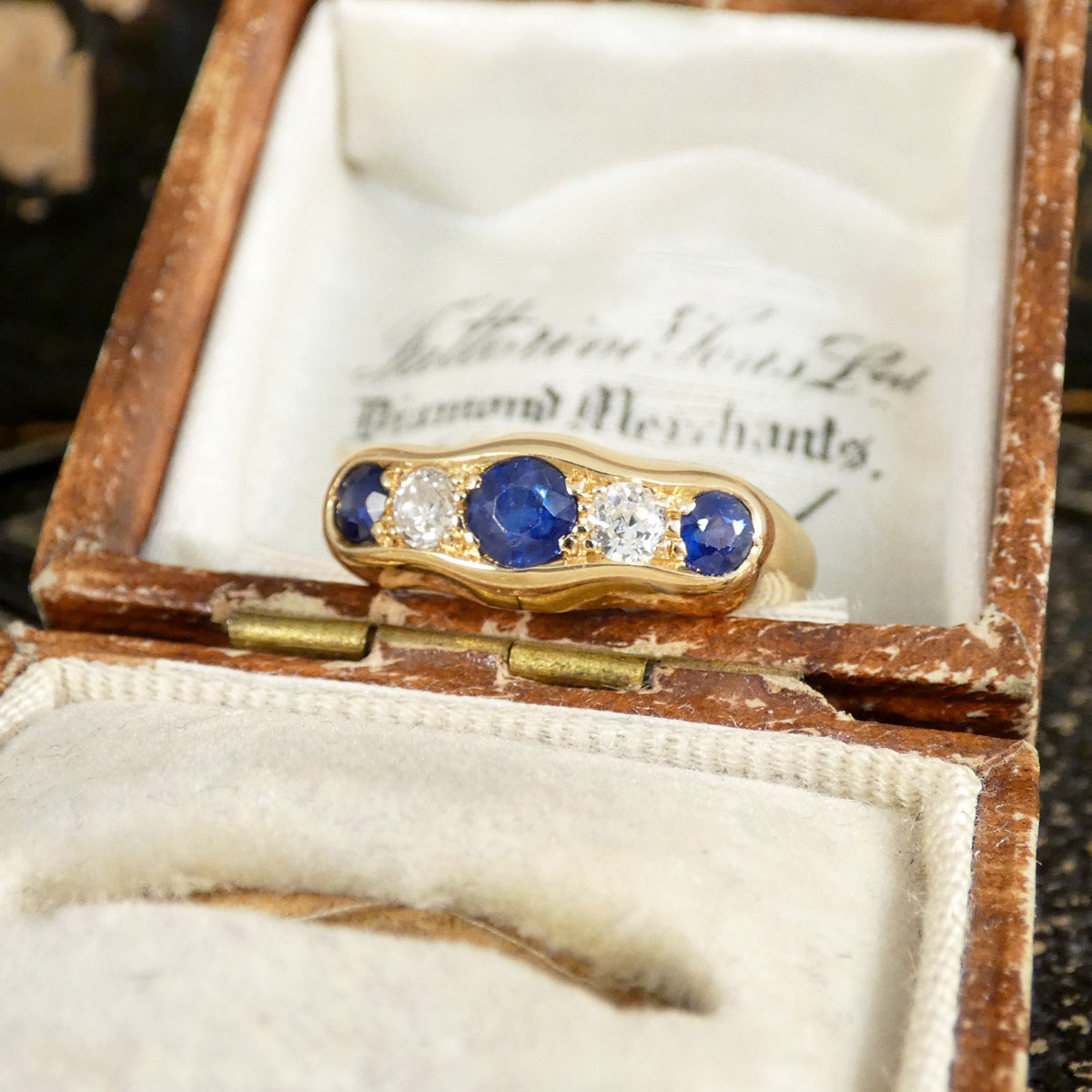 Gorgeous antique five stone ring displayed in an antique box.