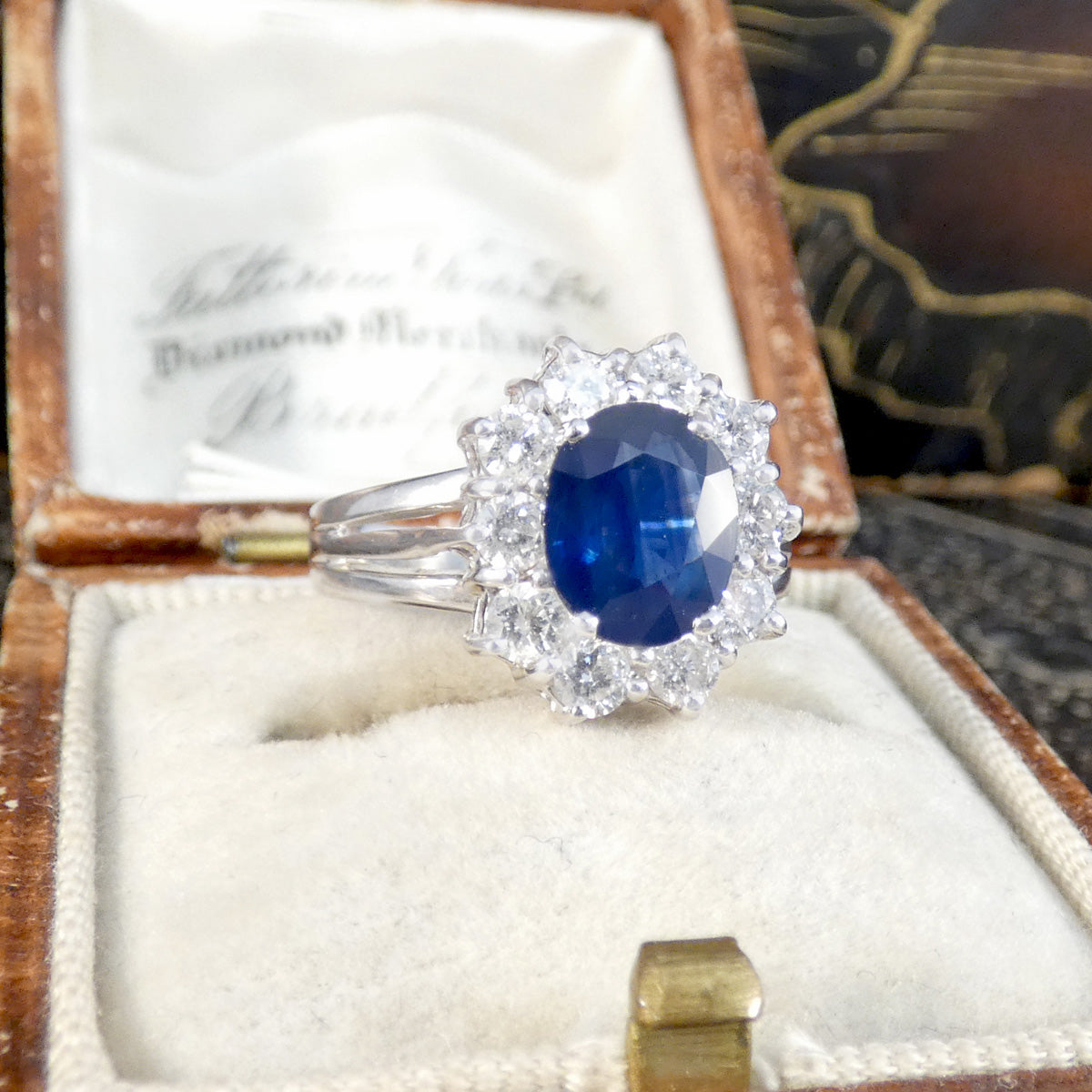 Diamond ring with a blue sapphire gemstone in an open jewelry box